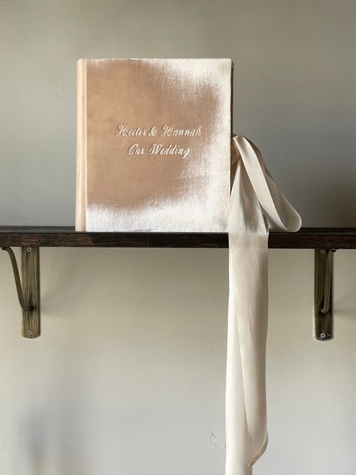 Free Chic wedding photo album with velvet cover and ribbon, perfect for preserving memories. Stock Photo