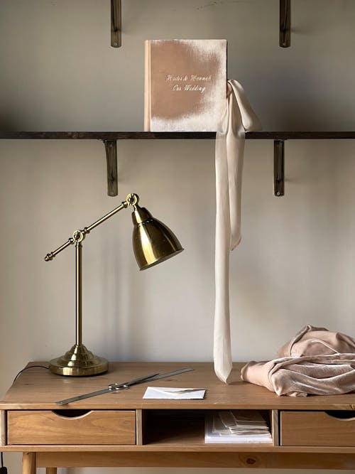 A desk with a lamp and a book on it