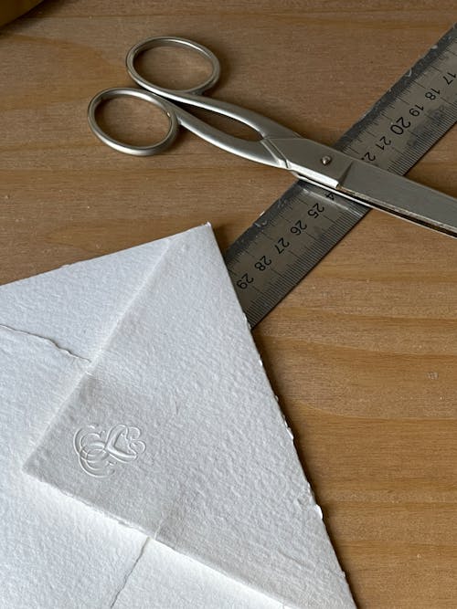 A pair of scissors and a piece of paper with a stamp