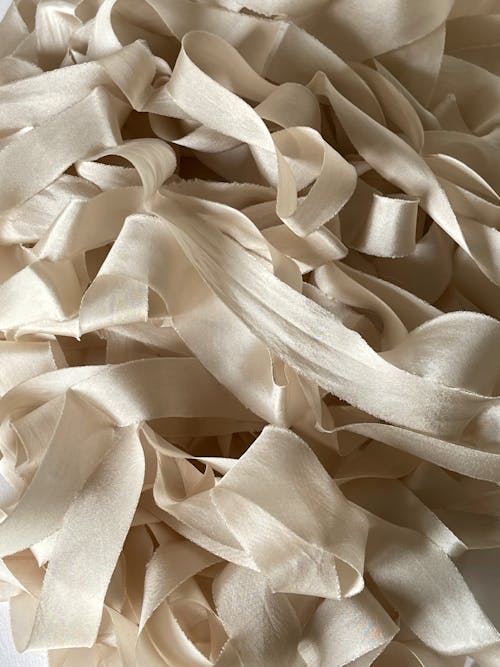 A pile of white ribbon on a white surface