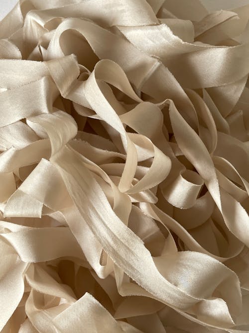 A close up of a pile of beige ribbon