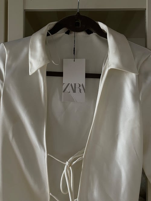 A white blazer with a tie on it