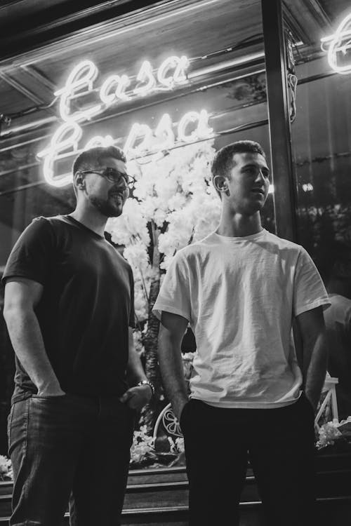 Two men standing in front of a restaurant