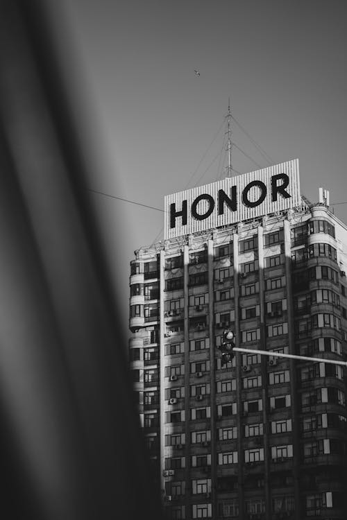 Black and white photo of a building with the word honor on it