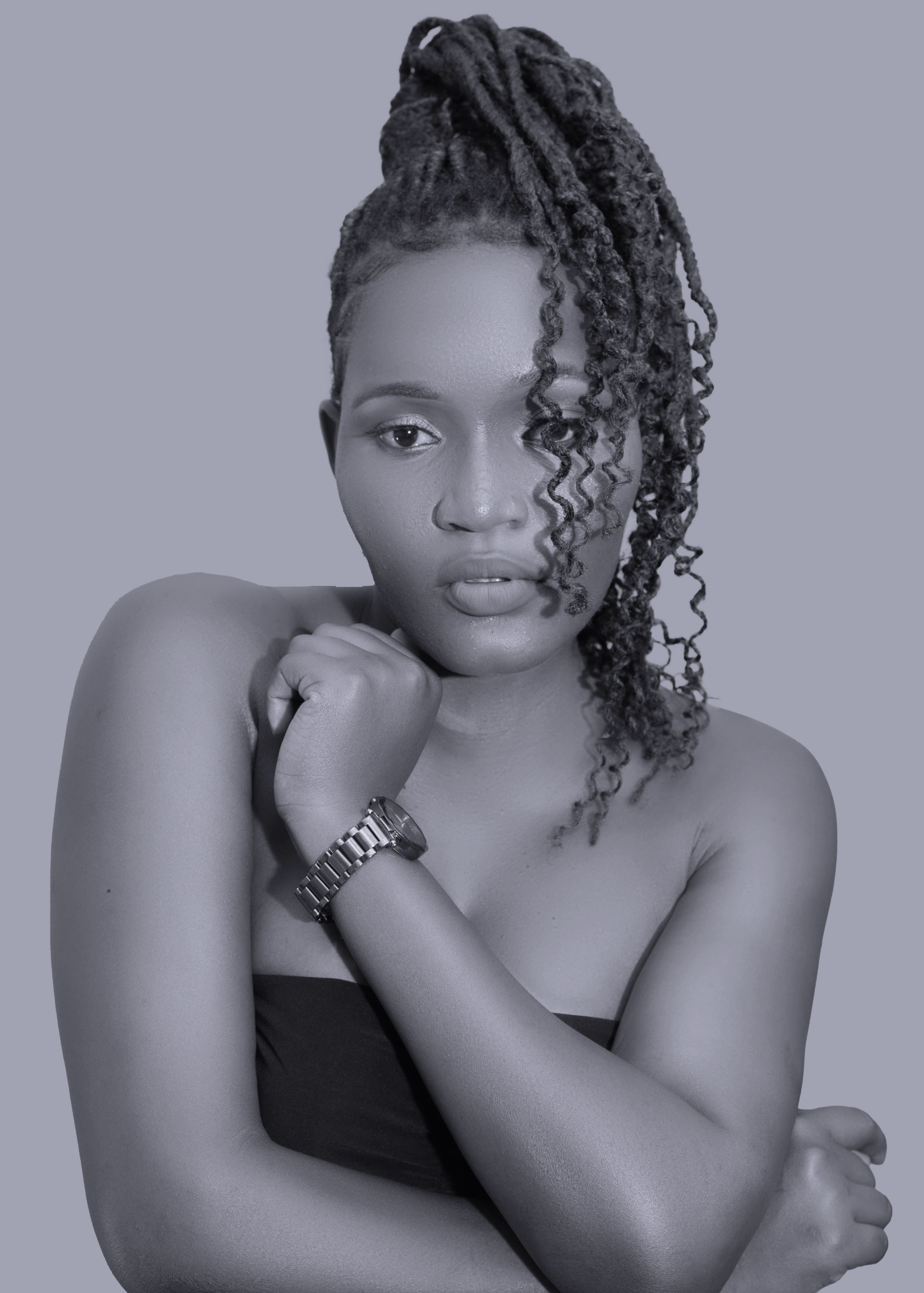 Stunning black and white portrait of a woman posing elegantly with a wristwatch, showcasing fashion and style.