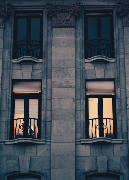 The windows of a building with the sun setting