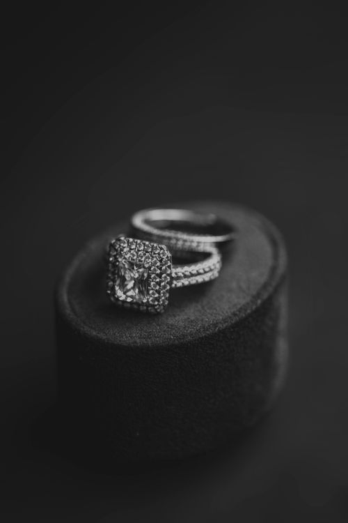 Free Close-up of a luxurious diamond ring on a display cushion, captured in classic black and white style. Stock Photo