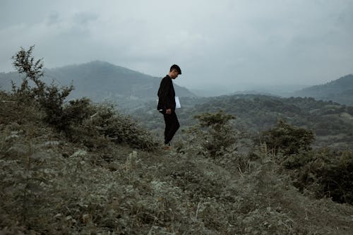 Person Standing in Mountain