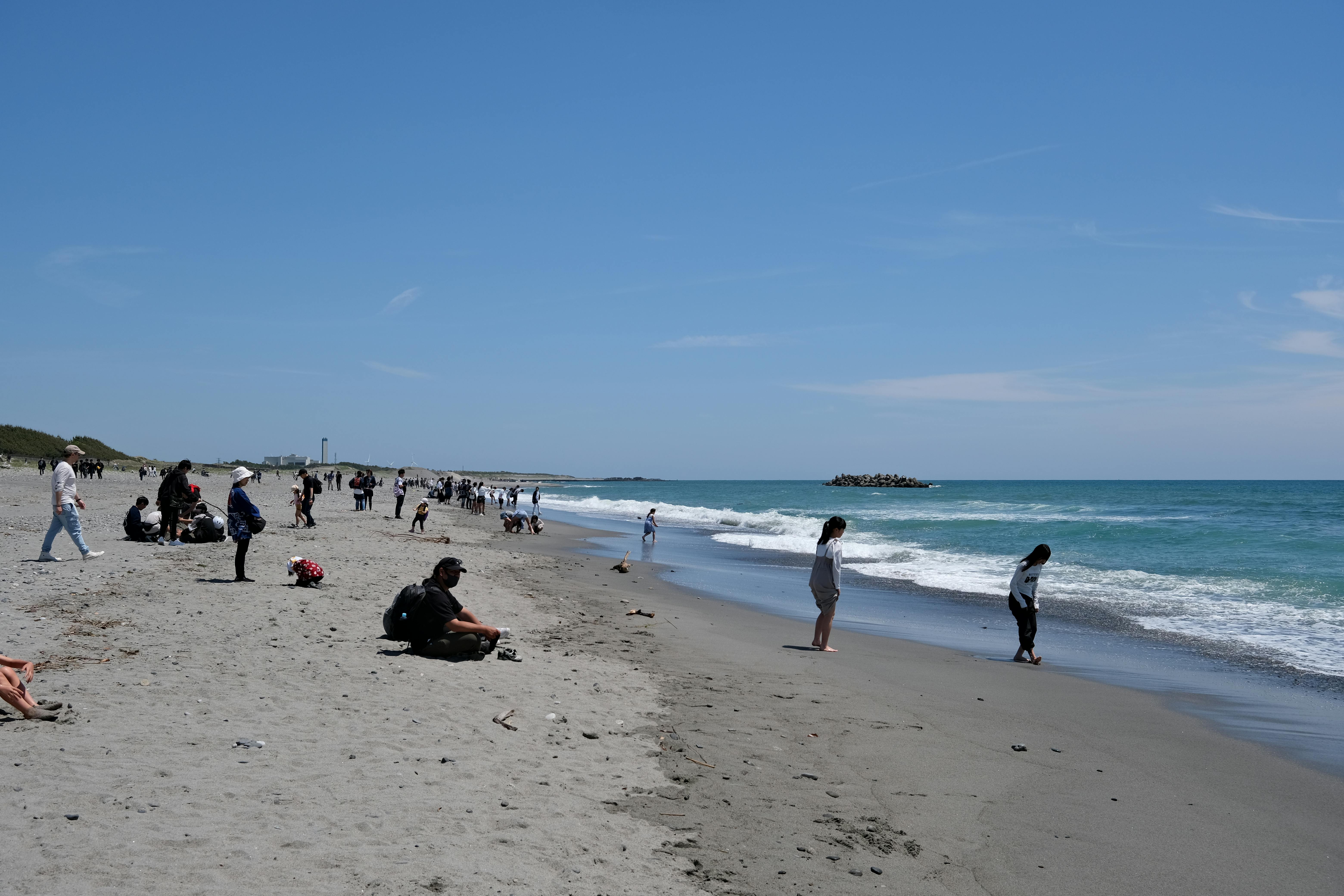 People enjoying a sunny day at the beach in Hamamatsu, Shizuoka, Japan.