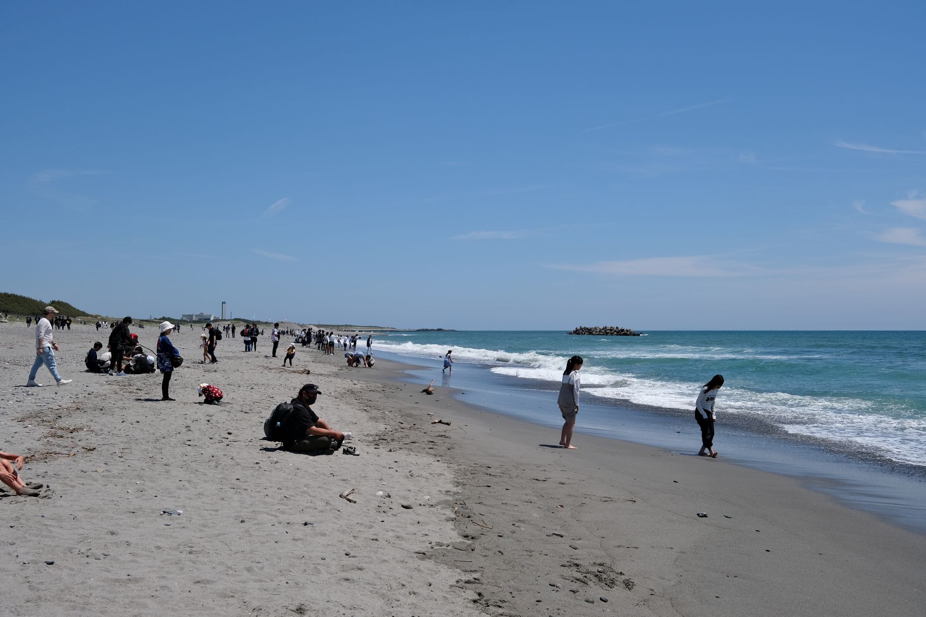 People enjoying a sunny day at the beach in Hamamatsu, Shizuoka, Japan.