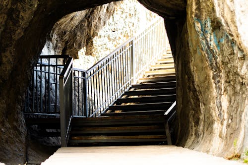 A stairway leading up to a cave with a railing