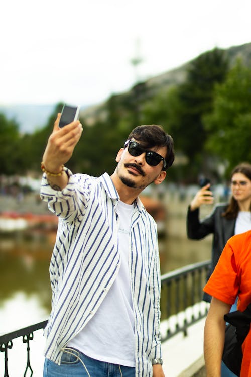 A man taking a selfie with his cell phone