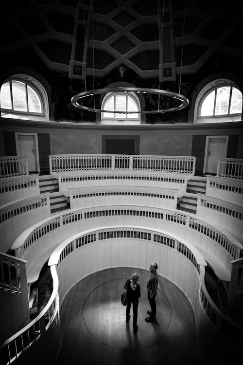 Free Black and white photo of two people standing in a circular room Stock Photo