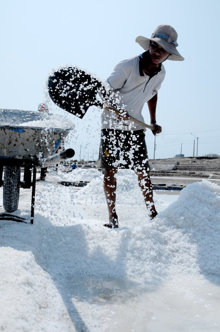 Asian Man Working On Salt