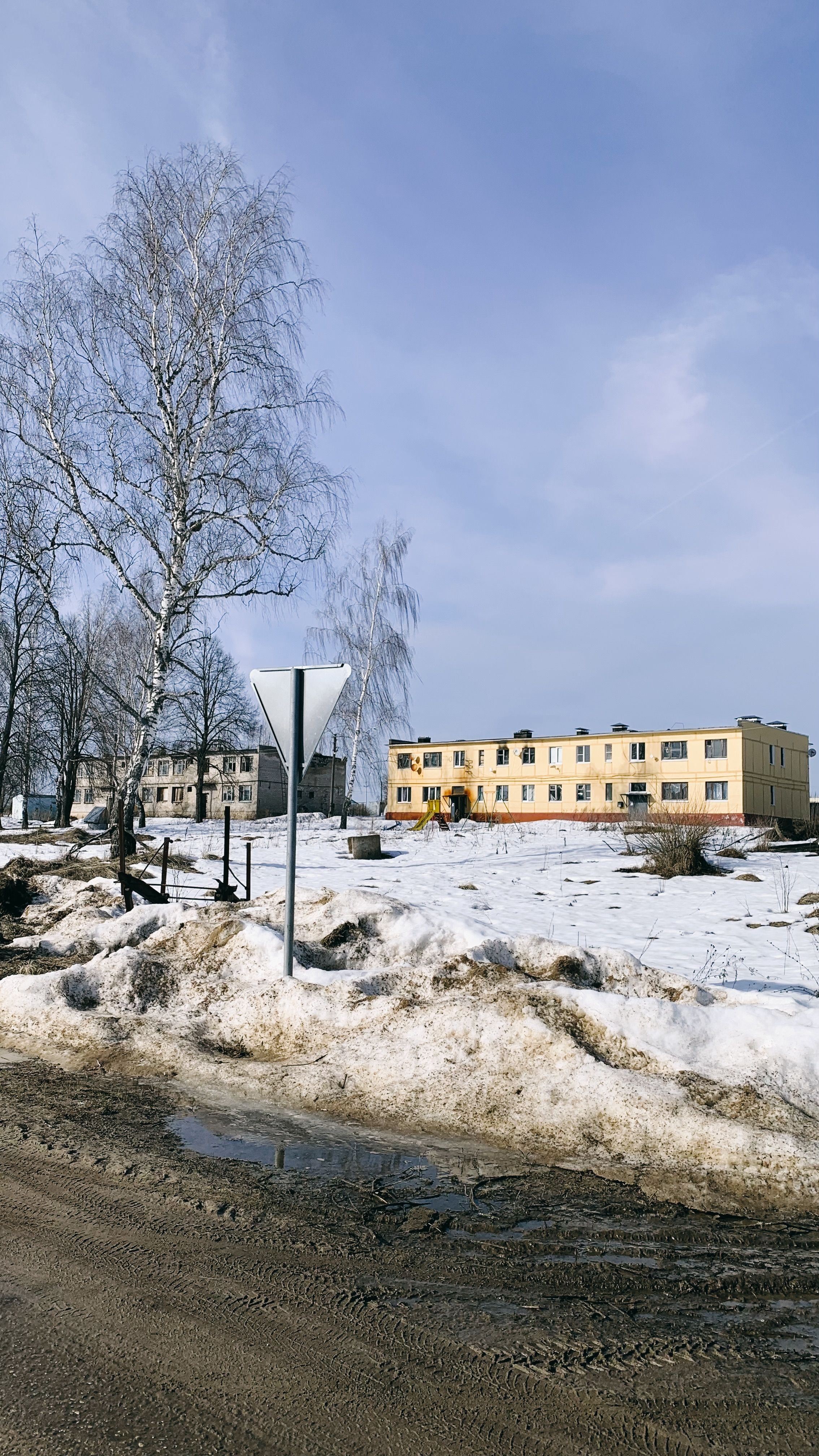 A scenic winter view featuring a snowy landscape and buildings under a clear sky.
