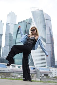 Stylish woman in urban city with modern skyscrapers, creating a vibrant fashion portrait.