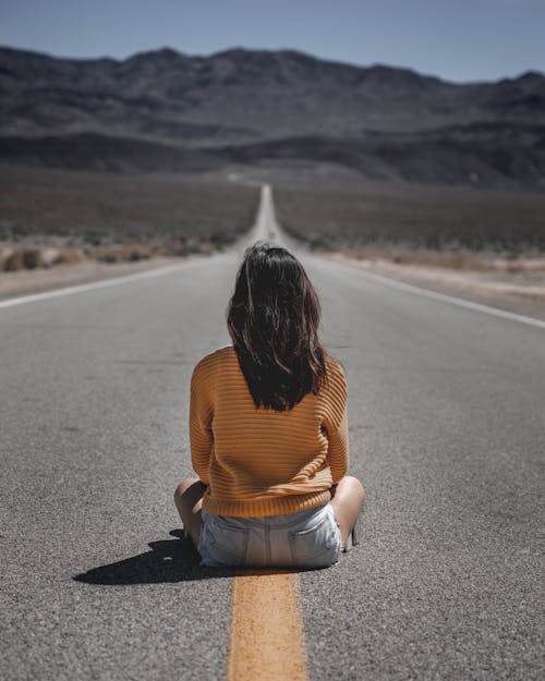 Woman Sitting on Road