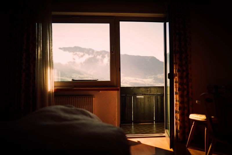 Cozy bedroom with sunset mountain view photography