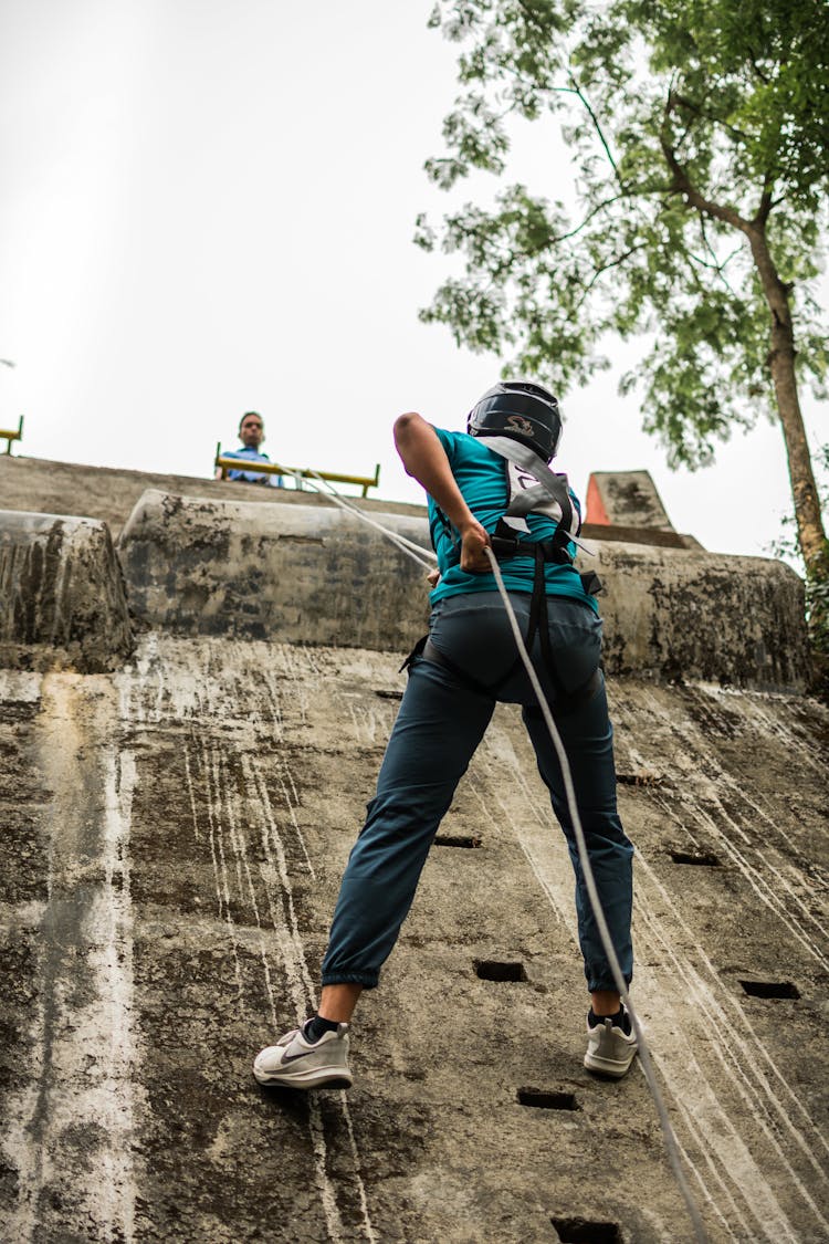 Person Climbing A Wall