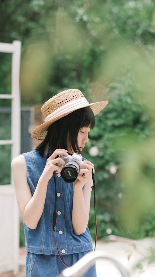 Portrait of Woman in Jean Vest and with Camera