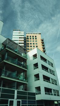 High-rise residential buildings under a clear sky showcasing modern urban architecture.