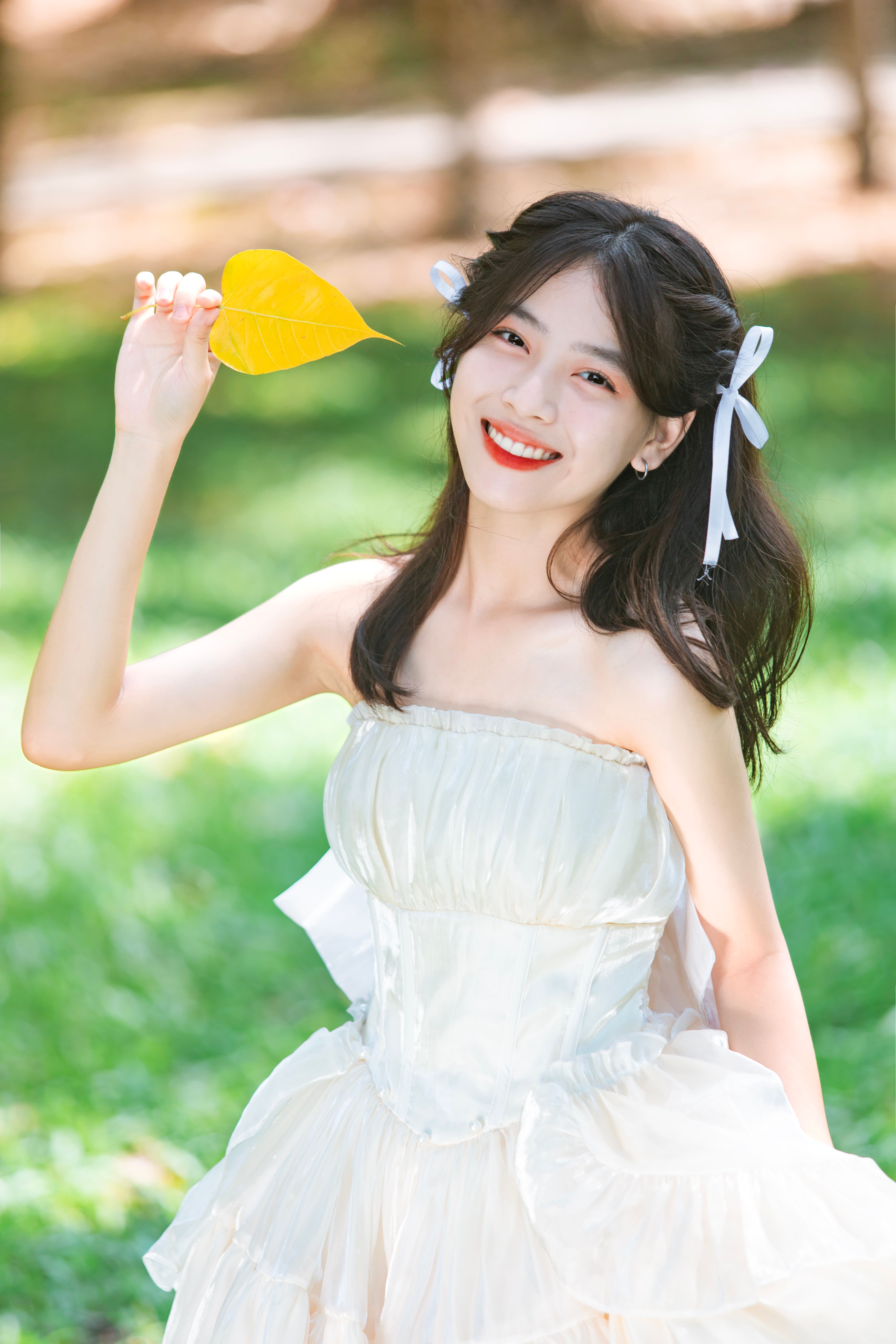 Smiling Brunette in White Dress · Free Stock Photo