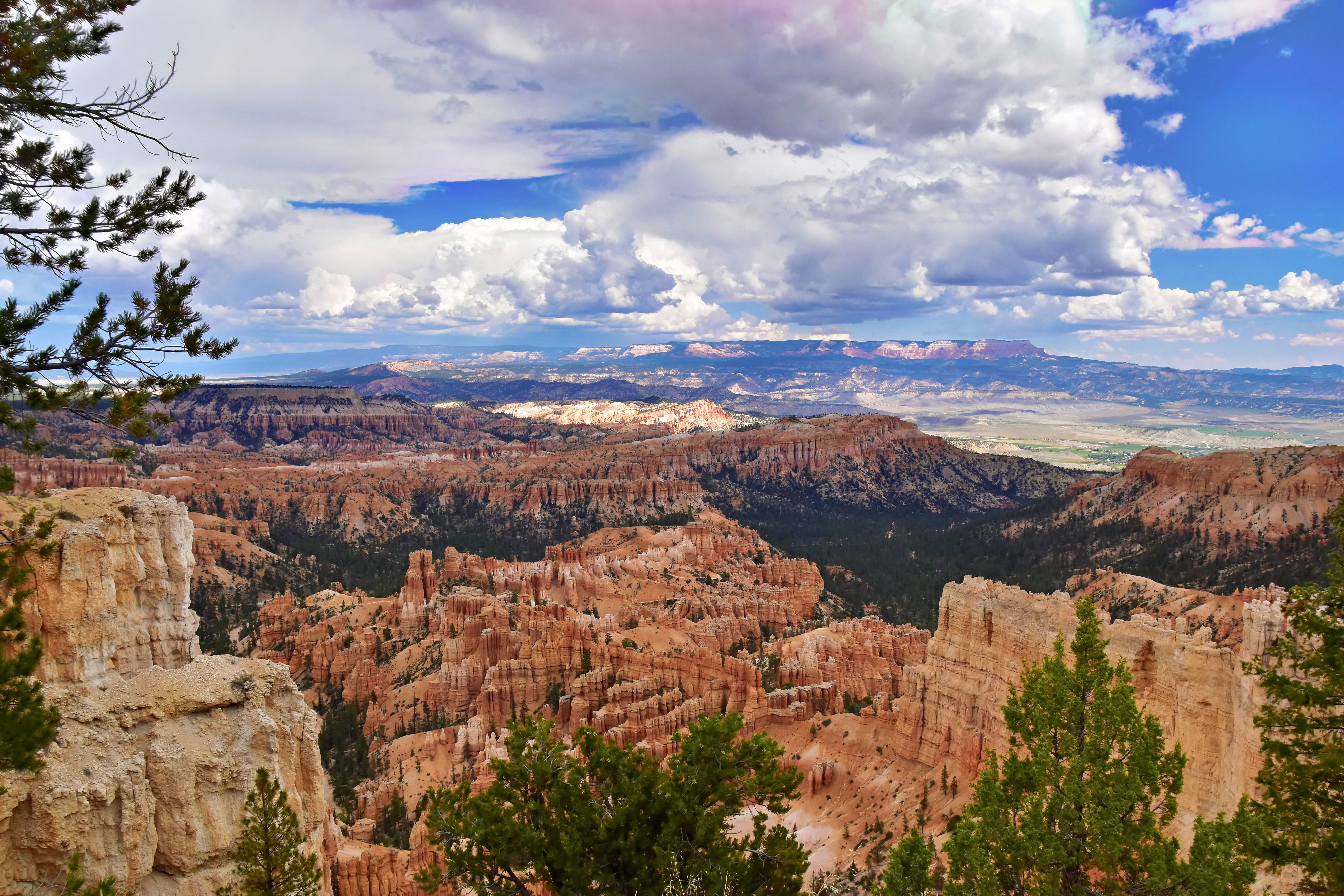 Scenic view of rock formations in Bryce Canyon National Park under a vast summer sky.