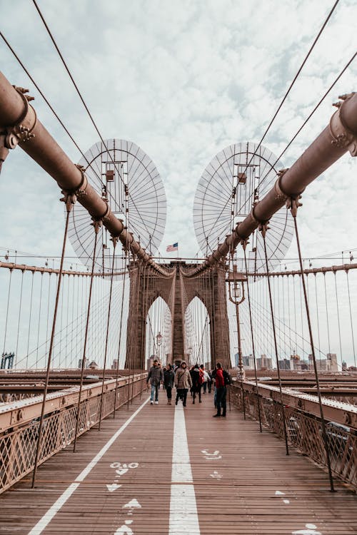 People Walking On Brooklyn Bridge New York