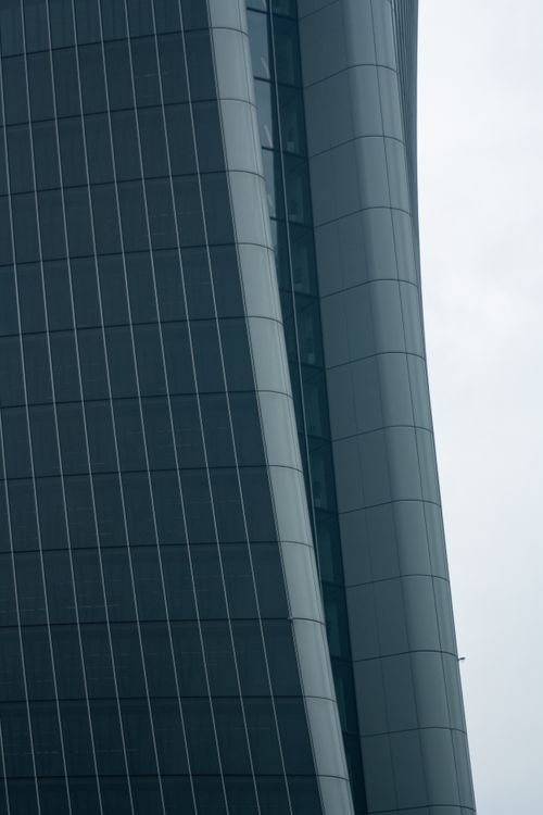 Free Close-up view of a modern skyscraper's glass facade in Milano, showcasing innovative design. Stock Photo