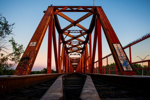 Free Capture of a red railway bridge over tracks in Pedro Meoqui, Mexico. Stock Photo