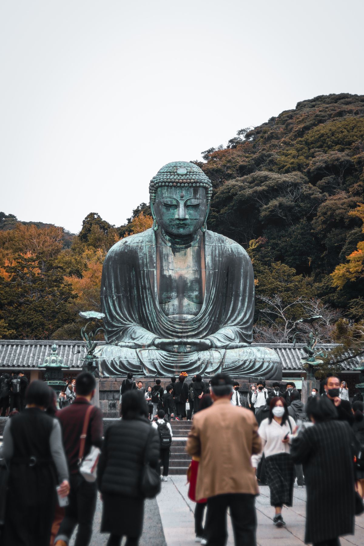 Visitors in front of the bronze Great Buddha of Kamakura at Kotoku-in