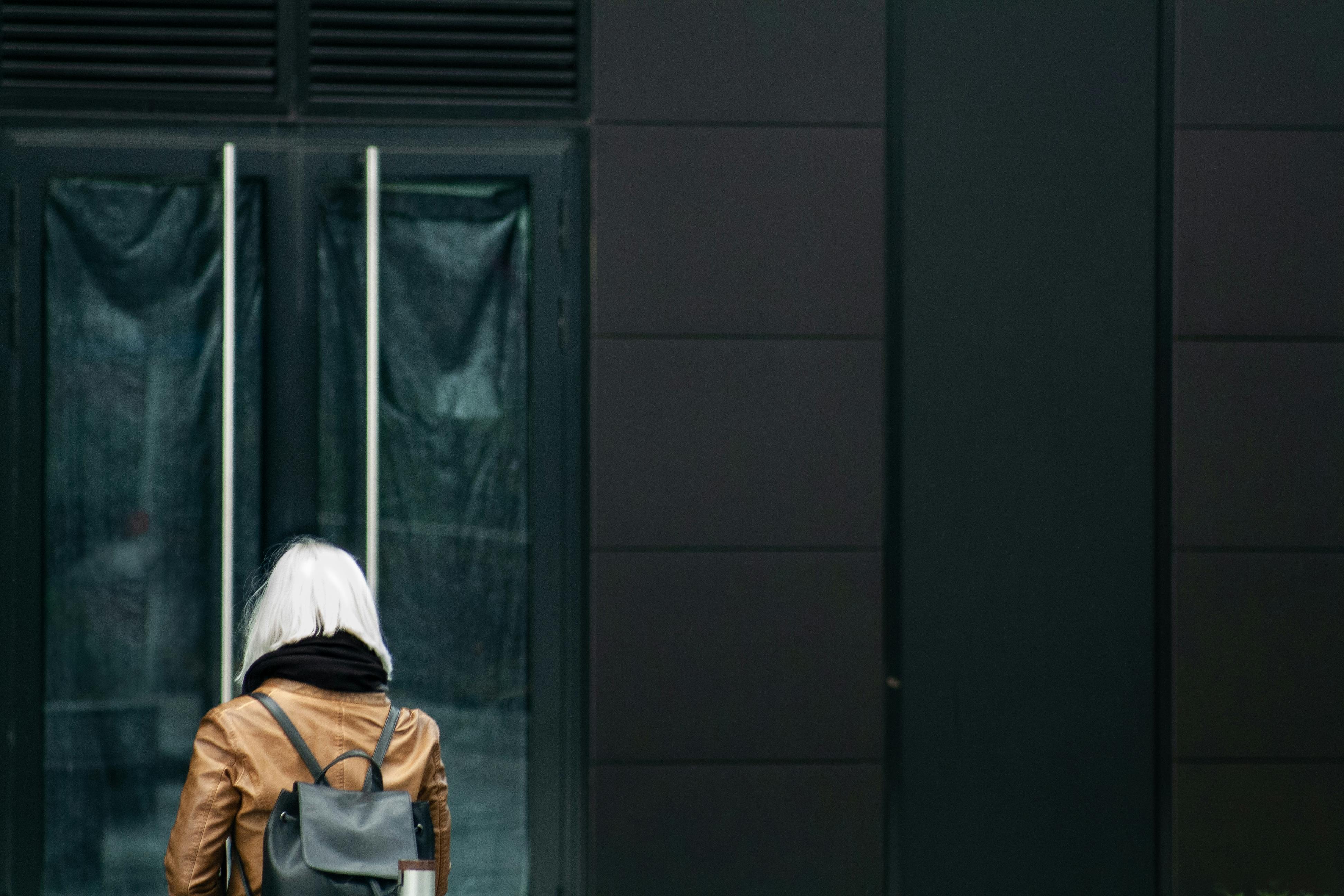 woman wearing brown jacket