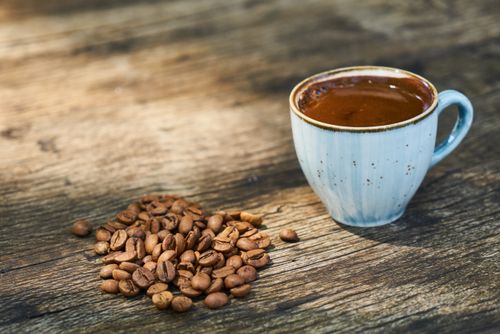 Free A cup of Turkish coffee with coffee beans on a wooden table, capturing the essence of Turkey. Stock Photo