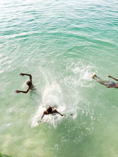 Free A group of people enjoying swimming in the turquoise waters of Tanzania. Stock Photo