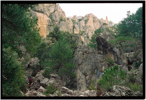 A person is hiking through a rocky area
