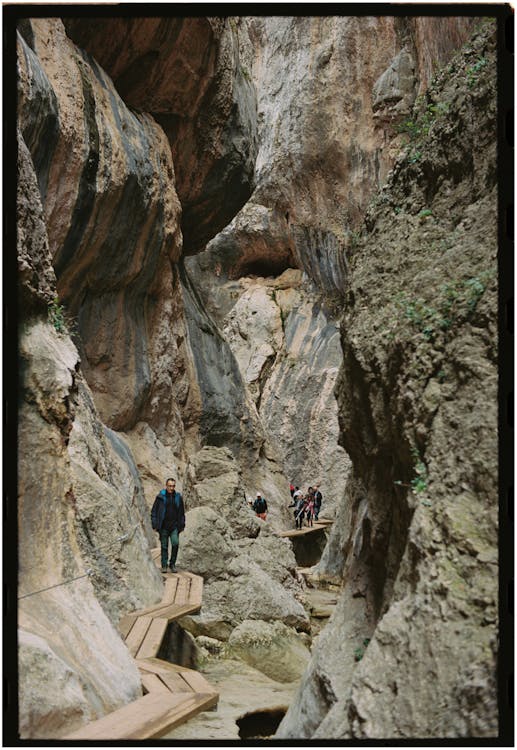 A group of people walking down a narrow path