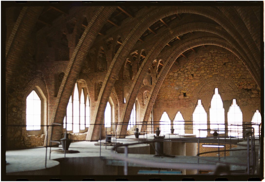The interior of a building with arches and windows