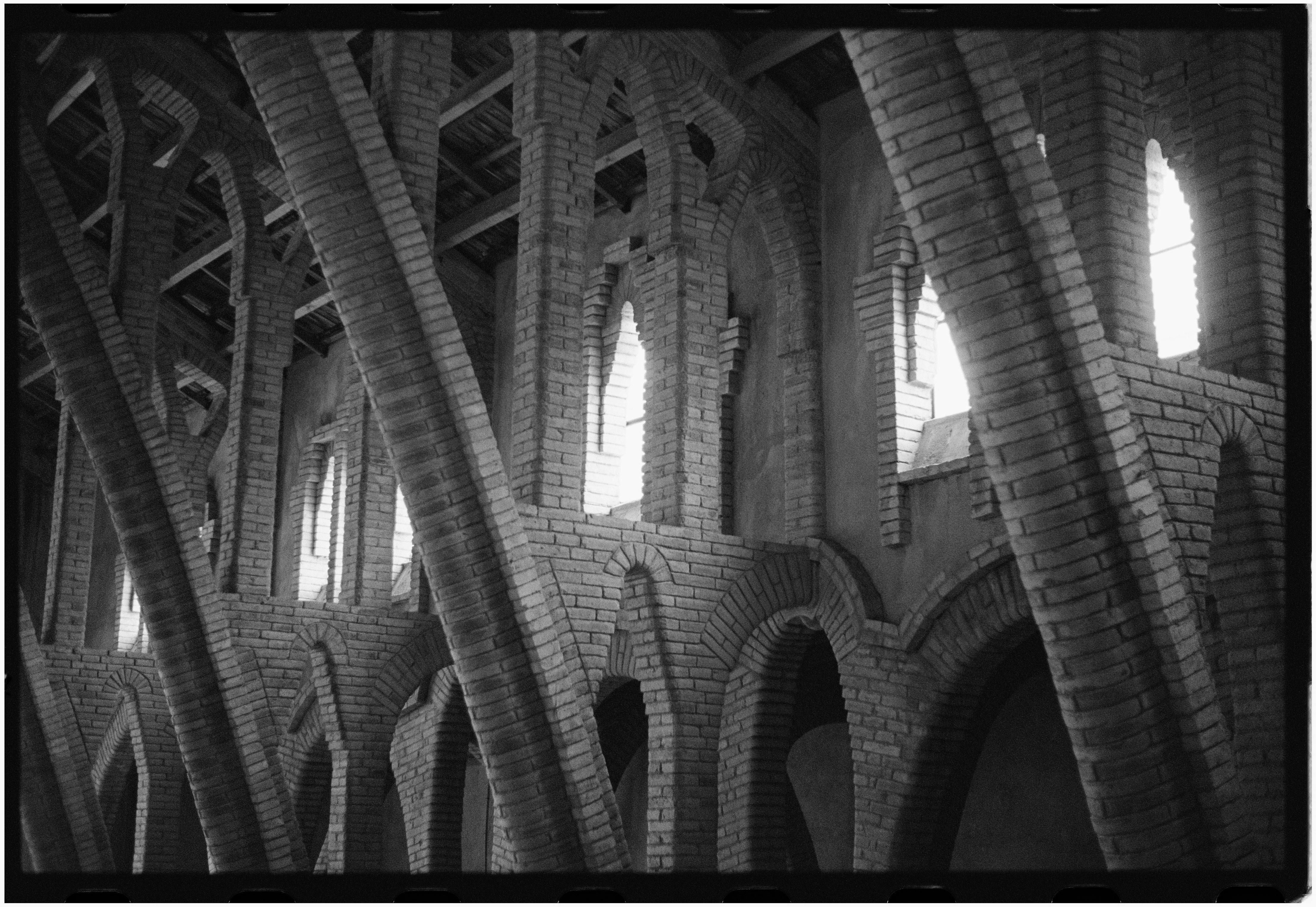 Black and white photo of arches and windows in a Spanish winery.