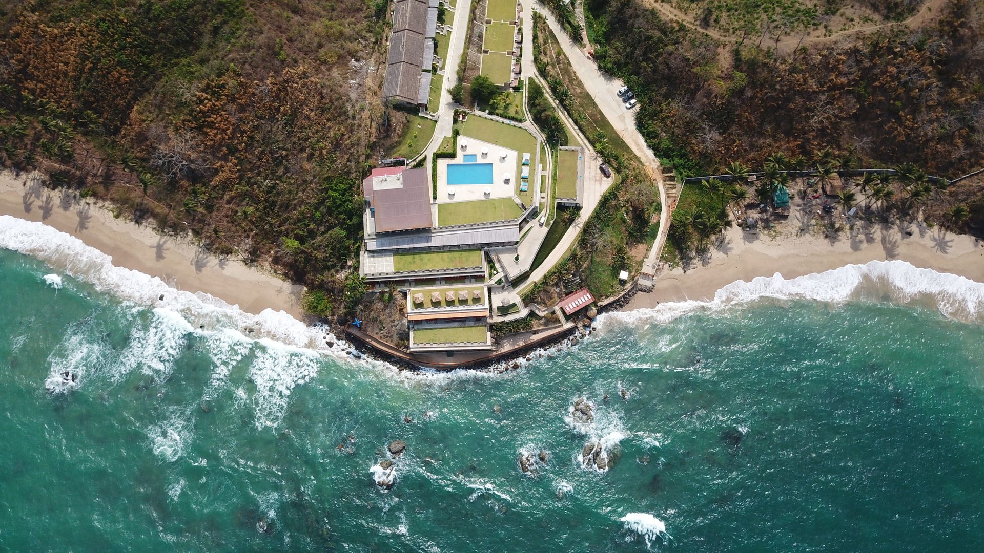 Drone shot of a resort by the beach in Pathein, Myanmar showcasing stunning coastal views.