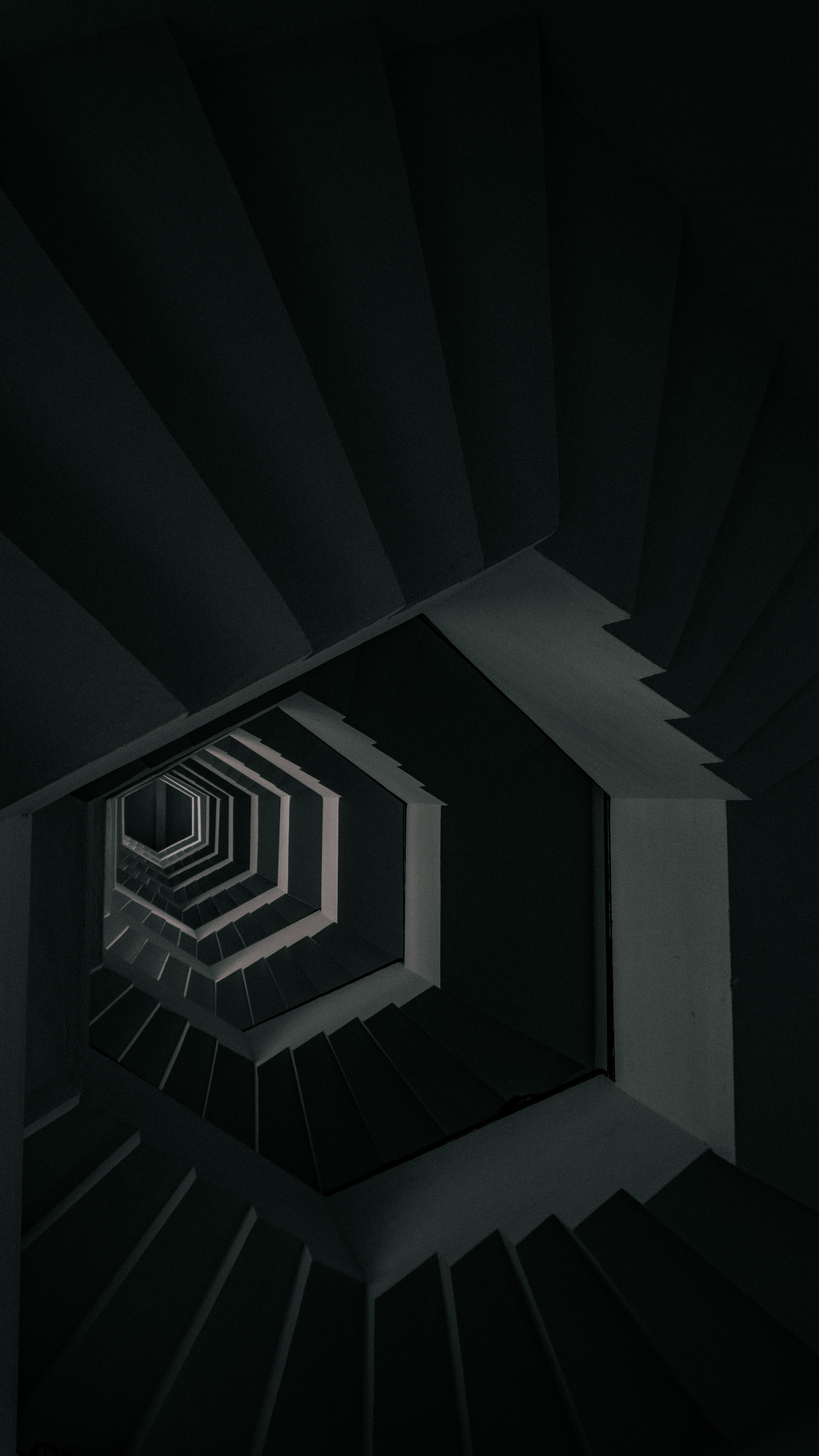 A geometric staircase in a dim modern building