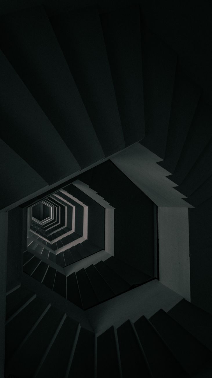 A geometric staircase in a dim modern building