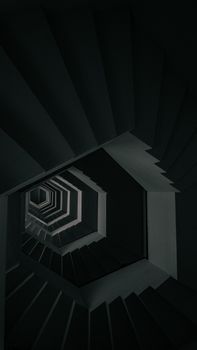 Dramatic view of a geometrical spiral staircase with dark shadows.