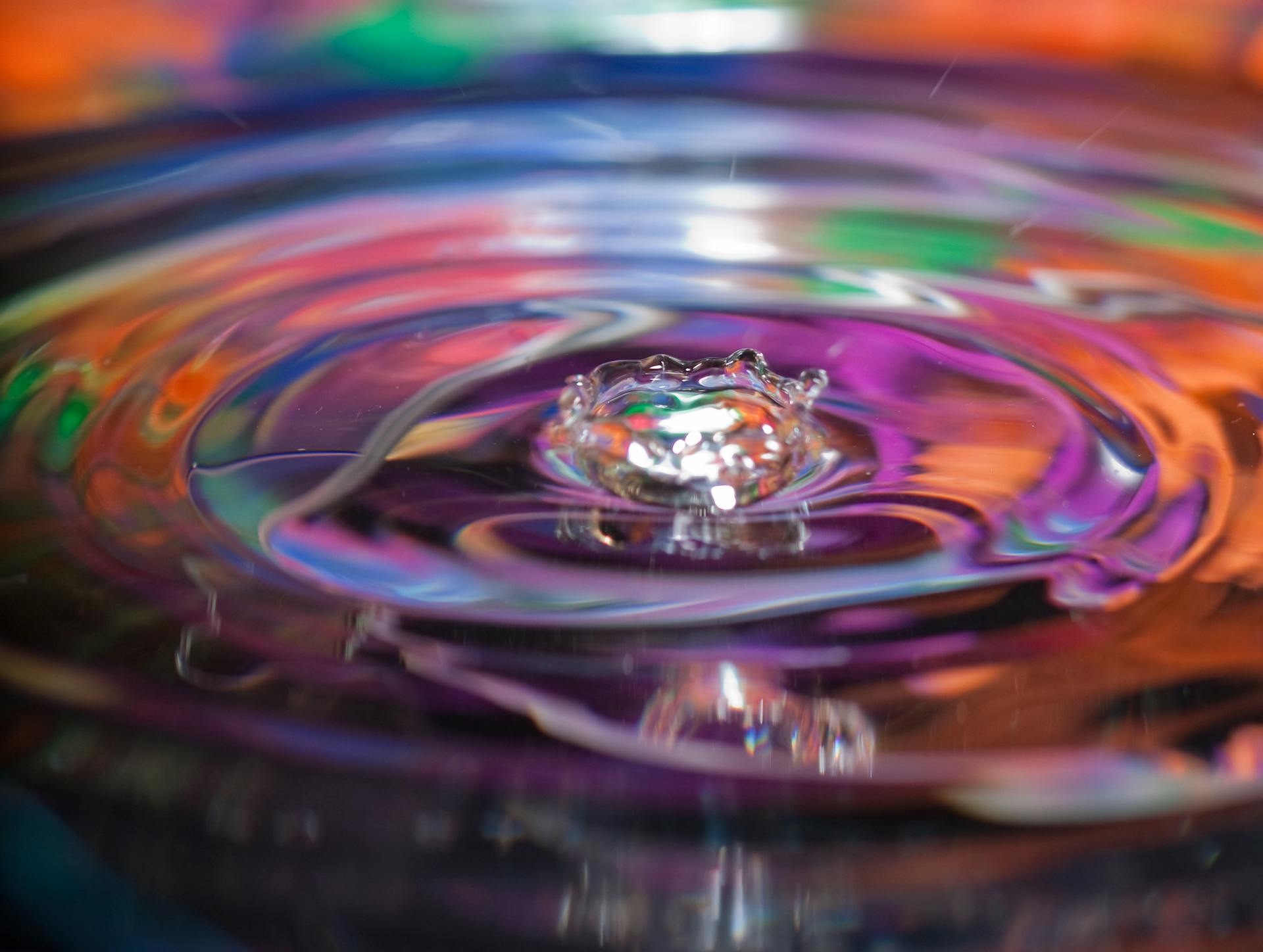 Vivid abstract photo capturing a colorful water ripple effect using long exposure. Perfect for artistic backgrounds.