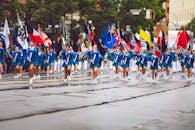 Women Wearing Blue Dress Parade Near Trees