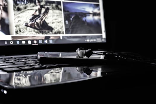 A digital setup of a laptop, smartphone, and earphones, showcasing modern technology use.