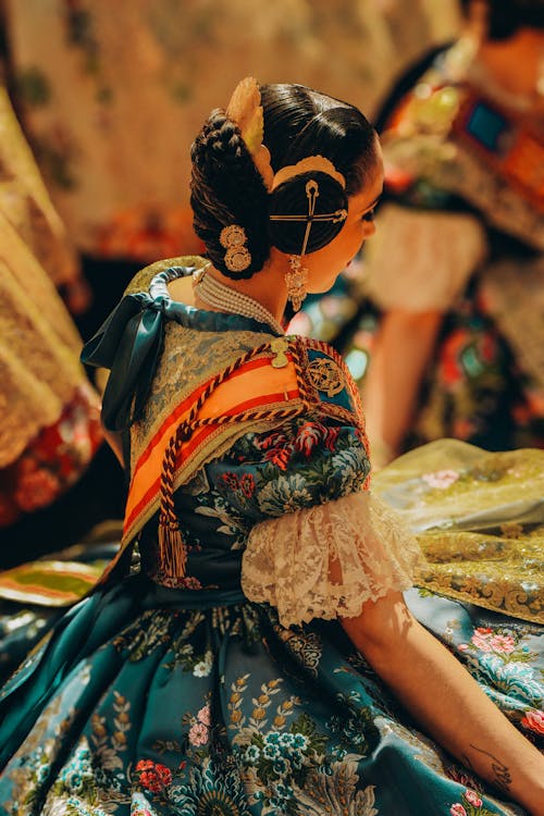 A woman in a traditional dress sitting on the floor