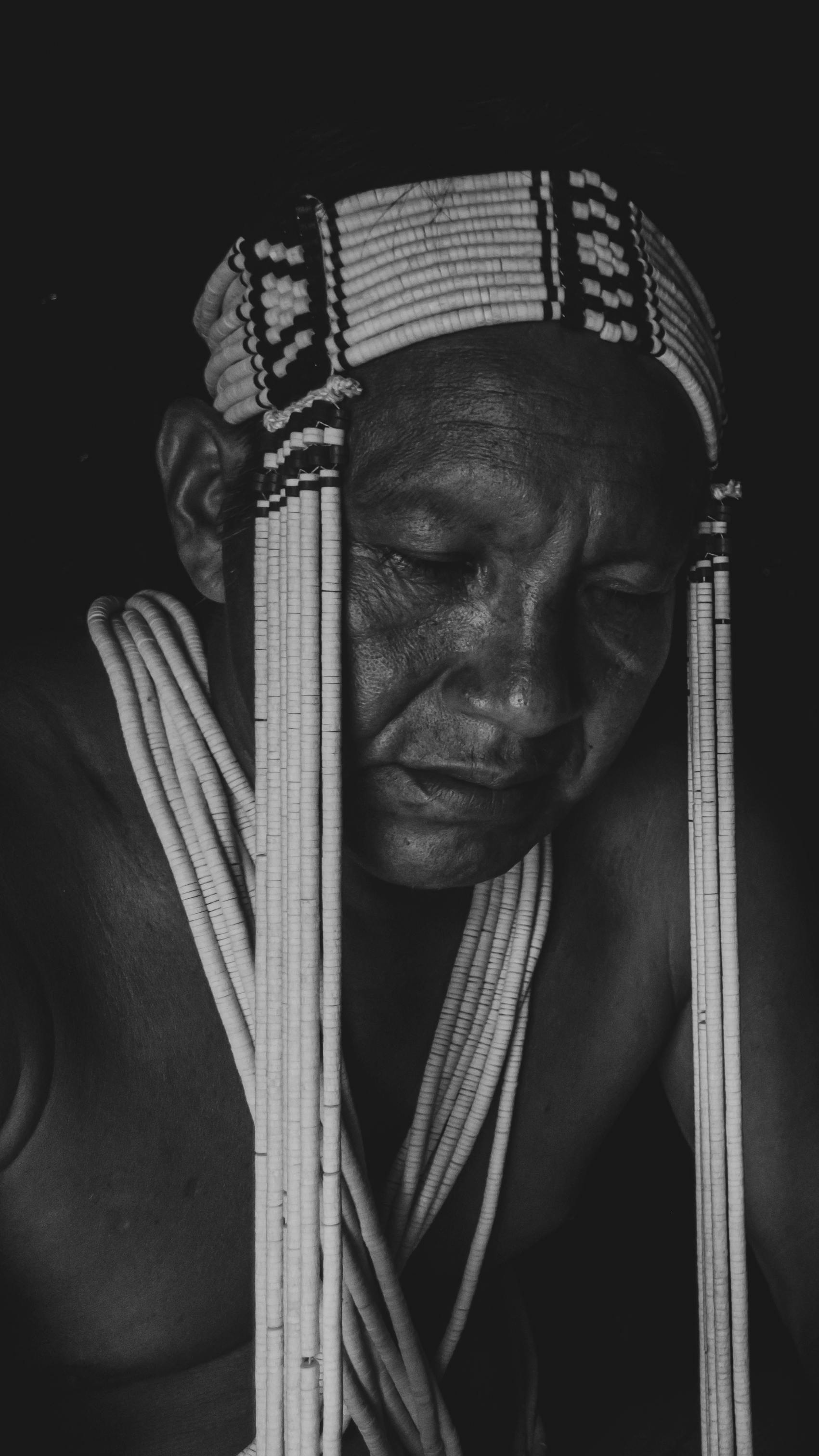 man wearing a traditional headdress and necklace