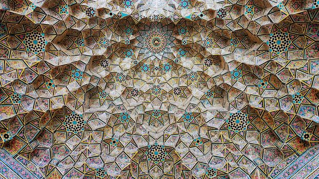 Beautiful geometric mosaic ceiling with colorful ornamental details in an Islamic architectural style.