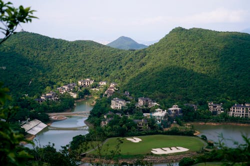 A view of a golf course surrounded by mountains