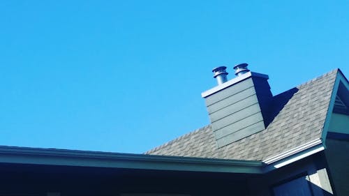 Free stock photo of apartment buildings, blue skies, chimneys